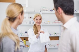 Pharmacist giving customers their prescription